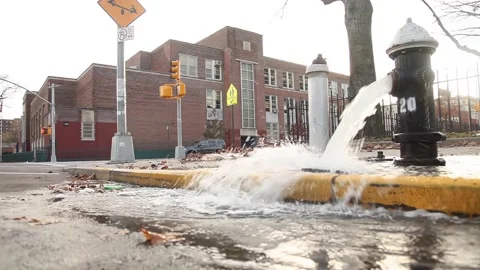 Broken fire hydrant water pouring out New York City street NYC Video stock 172459453