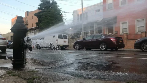Broken fire hydrant water shooting into street summer 4K and 1080 HD Stock Footage 95276324
