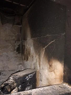 Broken firebrick in a tiled stove. Stock Photos