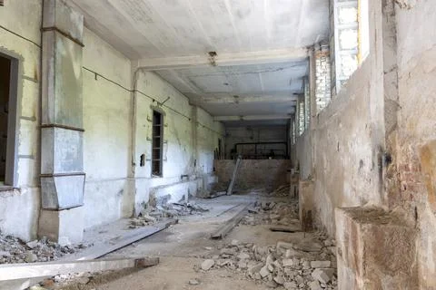 Broken floor, trash and clutter in an abandoned room Stock Photos