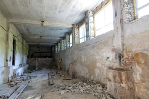 Broken floor, trash and clutter in an abandoned room Stock Photos