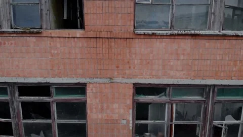 Broken frame and broken glass of a large window, red brick wall 스톡 동영상 150363820