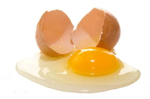 Broken free range egg on white background Stock Photos