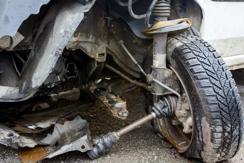Broken front wheel on a white car after traffic accident Stock Photos