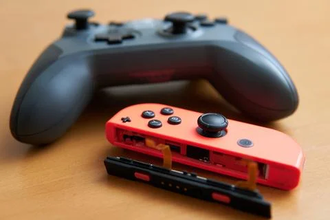 Broken game console controller and new controller Stock Photos