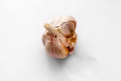 Broken garlic on a light  white background. Food photography Stock Photos