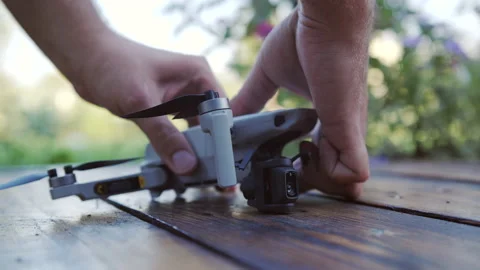 Broken gimbal camera after crash on old wood board. Close up. Garden. Summer day Stock Footage 170389621