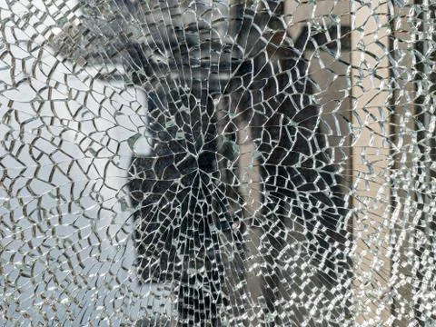 Broken glass background with a web pattern with the city in the background. D Fotos de archivo