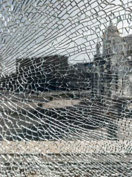 Broken glass background with a web pattern with the city in the background. D Stock Photos