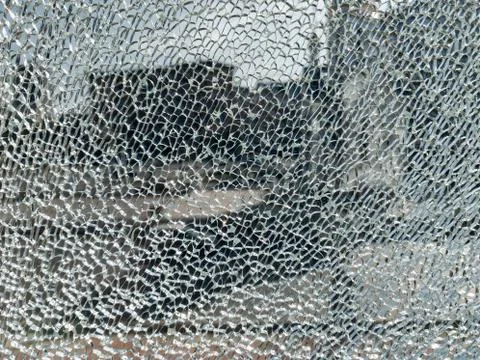 Broken glass background with a web pattern with the city in the background. D Stock Photos