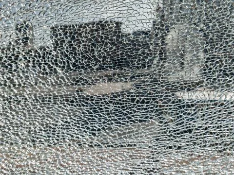 Broken glass background with a web pattern with the city in the background. D Stockfoto's