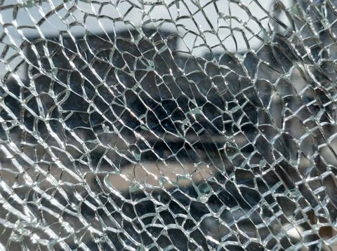 Broken glass background with a web pattern with the city in the background. D Fotos de archivo