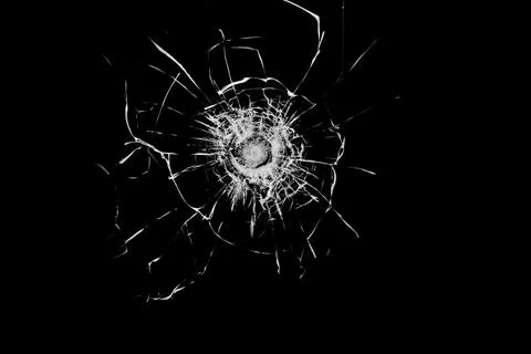 Broken glass from a bullet. Texture of broken glass. Stock Photos