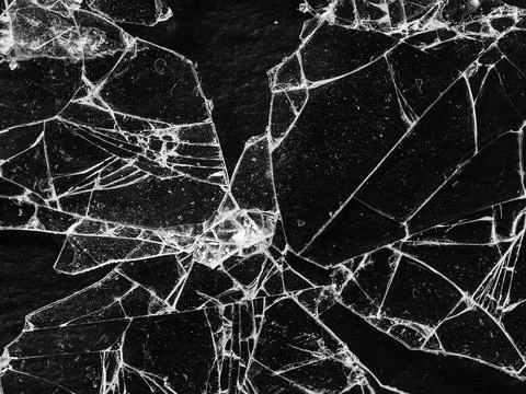 Broken glass on a dark background Stock Photos