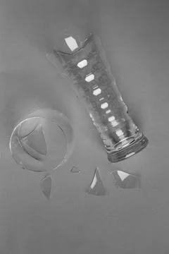 Broken glass on a gray background Stock Photos
