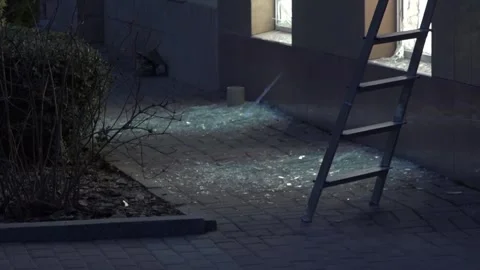 Broken glass on ground after storefront window damage Stock Footage 332619459