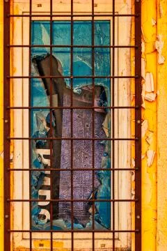 Broken glass in old window with rusty grid Stock Photos