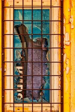 Broken glass in old window with rusty grid Broken glass in old window with... Stock Photos