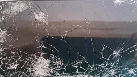Broken glass screen display with many sharp white spiderweb cracks Stock Photos