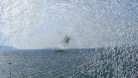 Broken glass with sea on background. Video stock 120767183