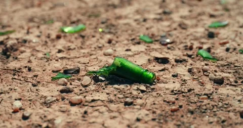 Broken Glass Shards Scattered Across Dry Cracked Desert Ground Stock Footage 321771492