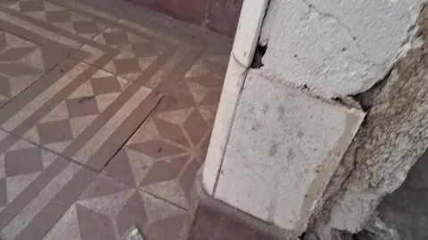 Broken glass shards scattered on patterned tiled floor motion video clip Stock Footage 337897025