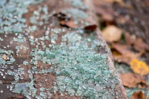 Broken glass on the sidewalk. Stock Photos