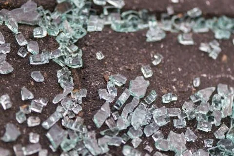Broken glass on the sidewalk. Stock Photos