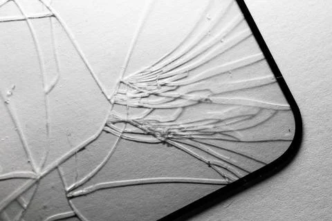 Broken glass surface with spider-web crack patterns Stockfoto's