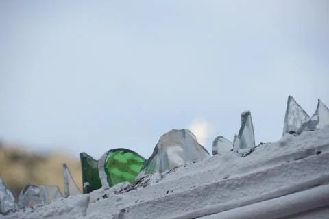 Broken glass in the upper part of a wall Stock Photos