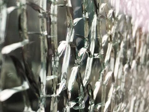 Broken glass wall shot at an angle with the blur at the right side of the frame Stock Photos