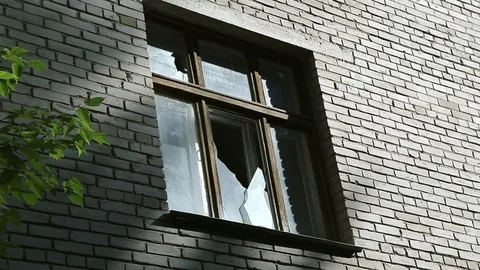 Broken glass in the window frame. Destruction or damage to public or private Stock Footage 110438505