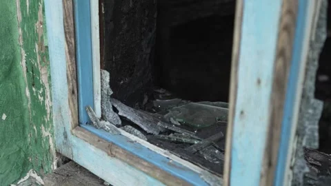 Broken glass window of an old burnt wooden house. Stock Footage 308929512