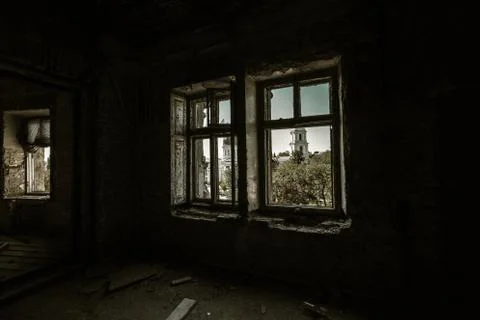 Broken glass in the windows of an old abandoned mystical house. A horror pict Stock Photos