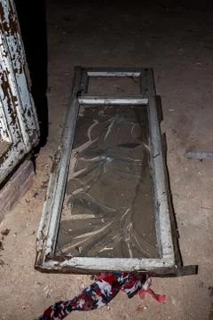 Broken glass in the windows of an old abandoned mystical house. A horror pict Stock Photos