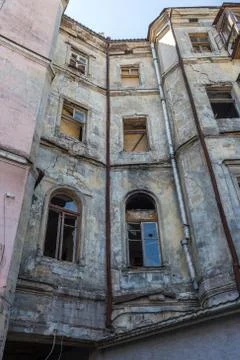 Broken glass in the windows of an old abandoned mystical house. A horror pict Stock Photos