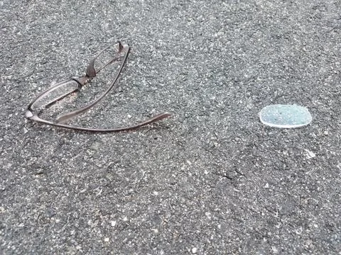 Broken glasses on asphalt Stock Photos