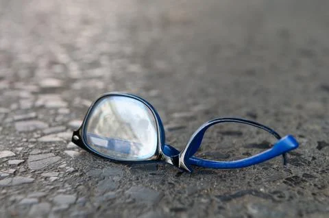 Broken glasses plastic frame damage fall on the concrete floor Stock Photos