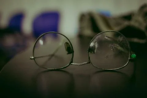 Broken glasses on a table your cell phone Foto stock
