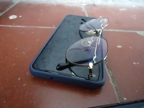 Broken glasses on a table your cell phone Stock Photos