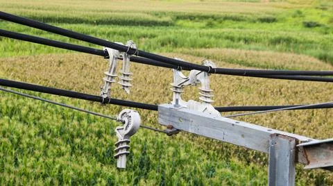 Broken gray high voltage cable spacers hanging on the cable Stock Photos