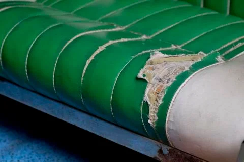 Broken green leather sofa Stock Photos