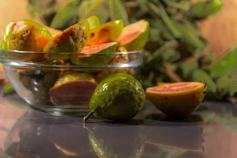 Broken guavas on a kitchen table and guava leaves in the background Stock Photos
