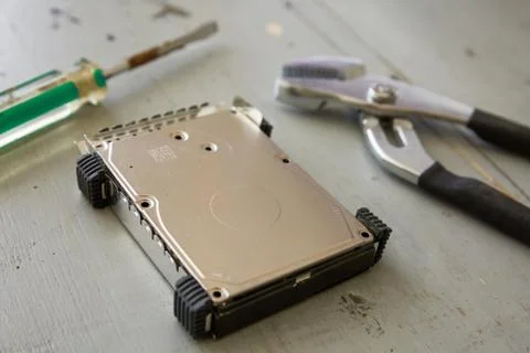 Broken Hard Drive Disk and Tools on Wooden Table Stock Photos