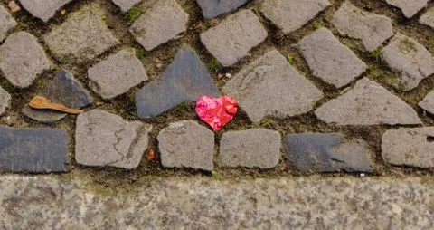 Broken heart on the cobblestone Stock Photos