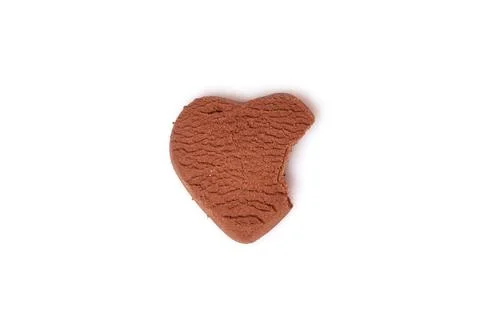 A broken heart. A half-bitten chocolate heart-shaped cookie Stock Photos