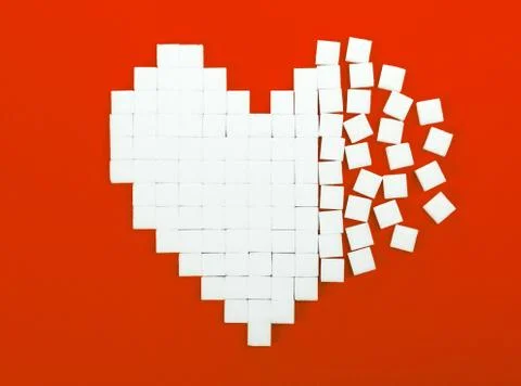 Broken heart made of sugar cubes Stock Photos