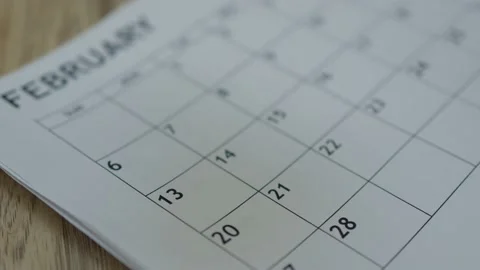 Broken heart two halves red paper falling on February 14 month calendar love Stock Footage 168737222