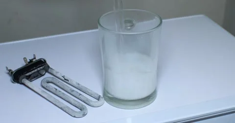 A broken heating element from a washing machine with limescale deposits is Stockbeeldmateriaal 254001685