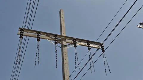 Broken high voltage electrical power line jumper wire hanging from concrete. Stock Photos